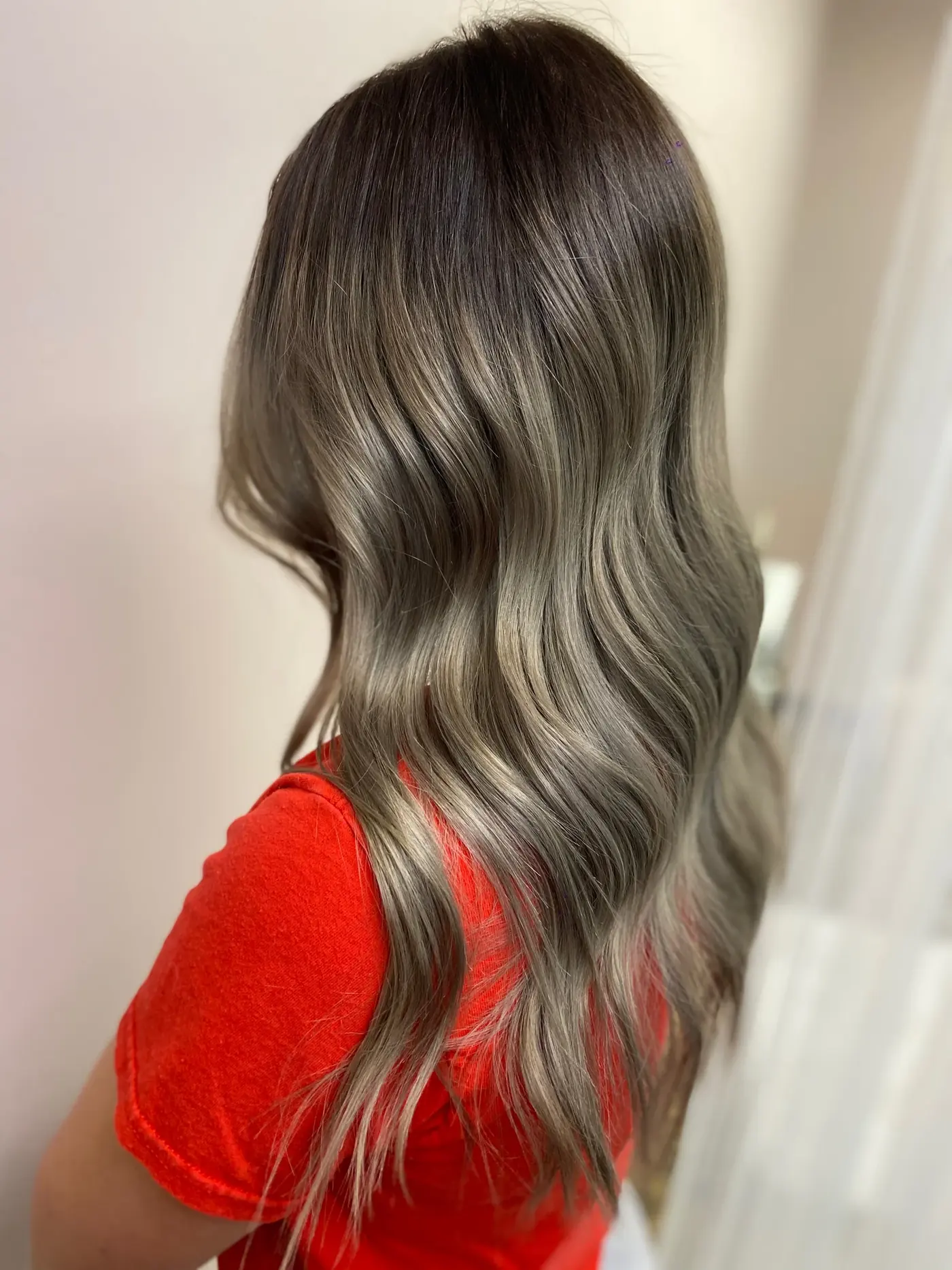 Long ash-blonde dimensional colour falling in soft waves